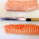 cutting salmon into sashimi photo