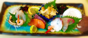 creative sashimi asortment with sideway plate